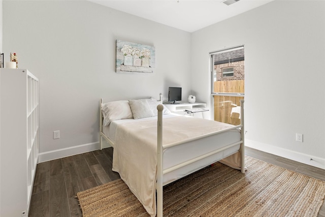 bedroom with dark hardwood / wood-style floors