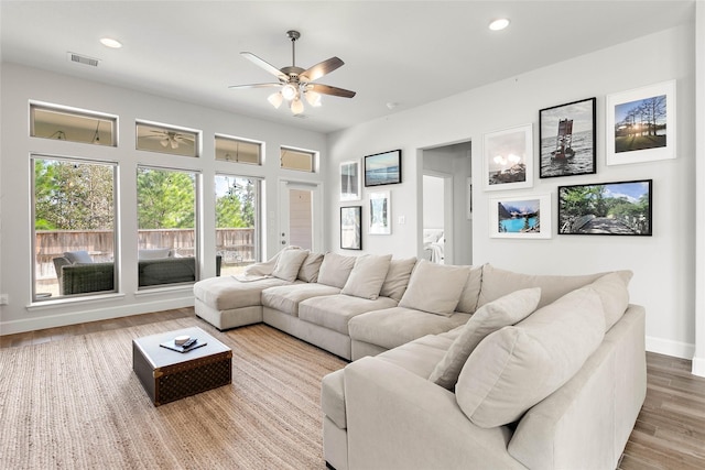 living room featuring ceiling fan and hardwood / wood-style floors