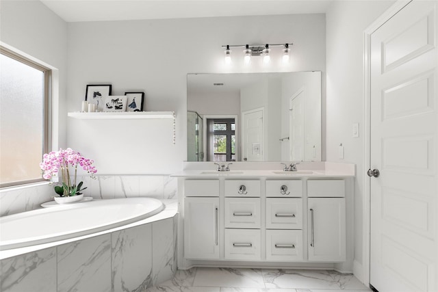 bathroom with vanity and shower with separate bathtub