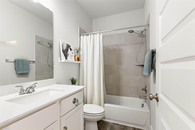 full bathroom with vanity, shower / tub combo, hardwood / wood-style flooring, and toilet