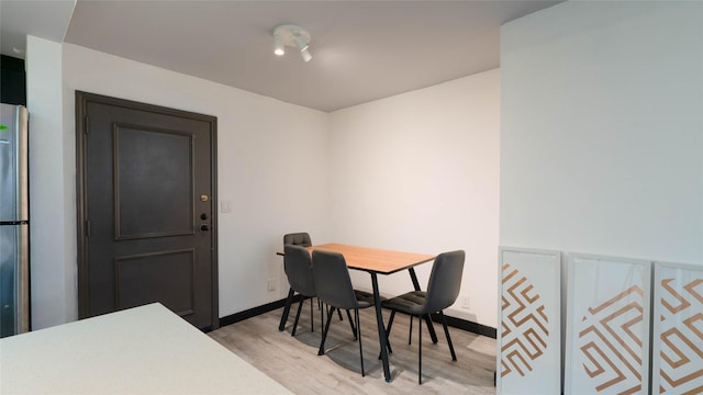 dining space with light hardwood / wood-style flooring