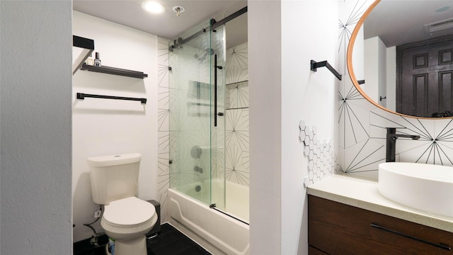 full bathroom featuring vanity, decorative backsplash, shower / bath combination with glass door, and toilet