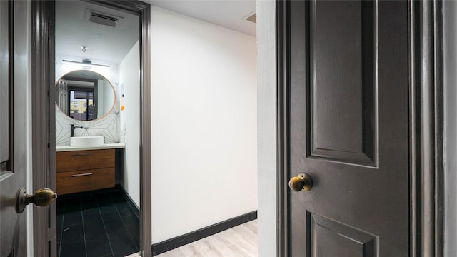 bathroom with vanity and wood-type flooring