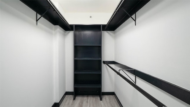 spacious closet featuring hardwood / wood-style floors