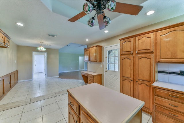 kitchen featuring pendant lighting, light tile patterned floors, a center island, and ceiling fan