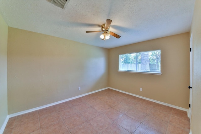 unfurnished room with light tile patterned floors, a textured ceiling, and ceiling fan