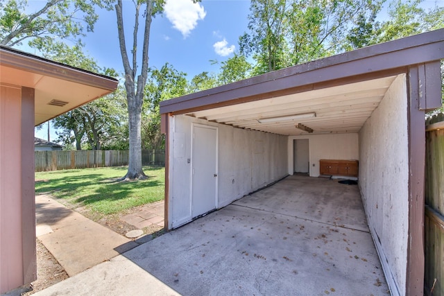 view of car parking with a lawn and a carport