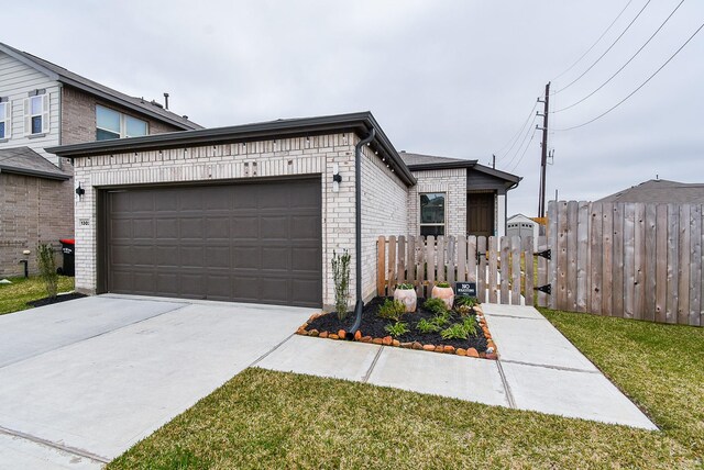 view of front of home featuring a garage and a front lawn