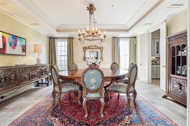 dining space featuring crown molding, a wealth of natural light, a chandelier, and a tray ceiling