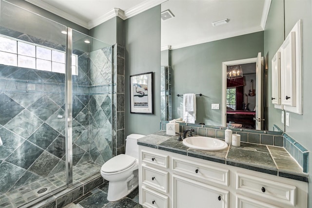 bathroom with a shower with door, crown molding, a healthy amount of sunlight, and vanity