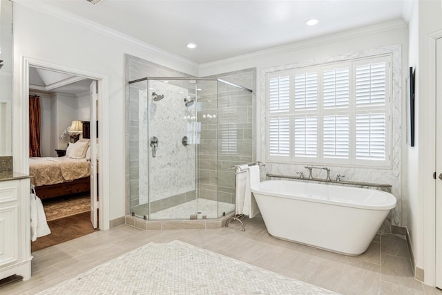 bathroom with ornamental molding and separate shower and tub