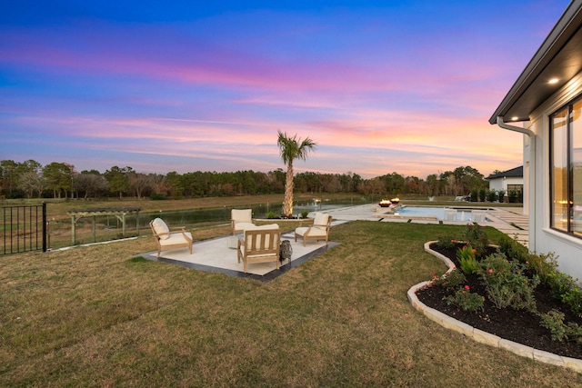 view of yard featuring a patio, fence, and an outdoor pool