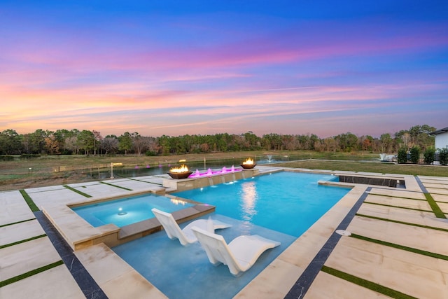 view of pool featuring a pool with connected hot tub and a patio