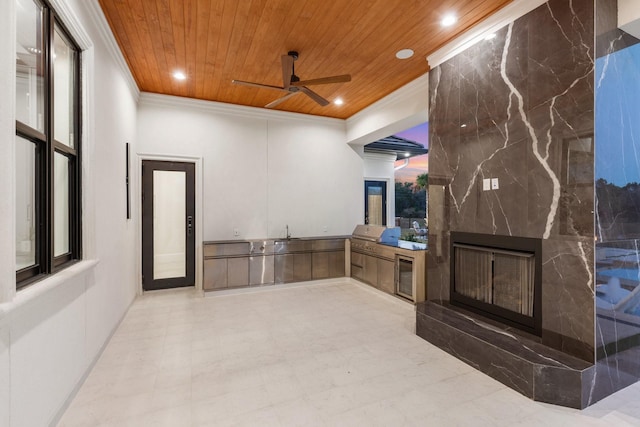 living room featuring ornamental molding, recessed lighting, wooden ceiling, and a premium fireplace