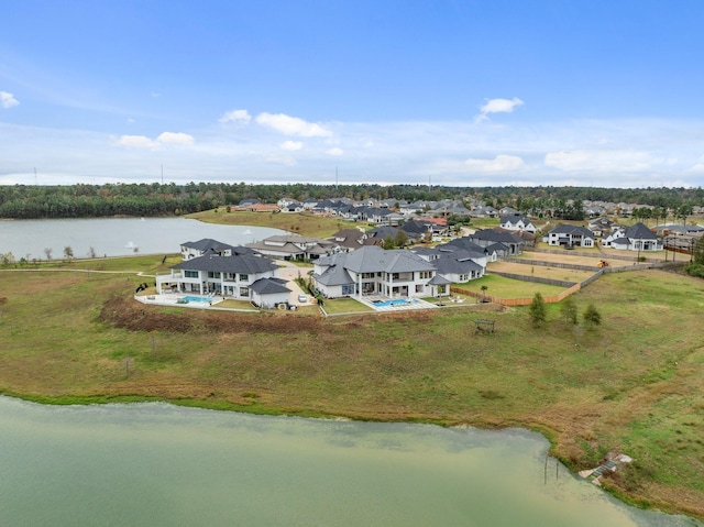 birds eye view of property with a water view and a residential view