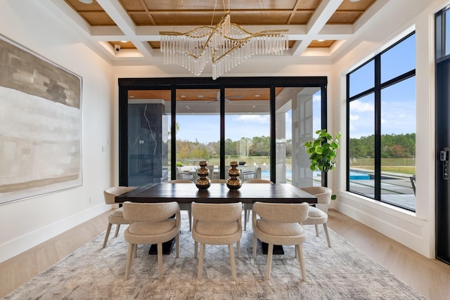 dining area with plenty of natural light, baseboards, and wood finished floors