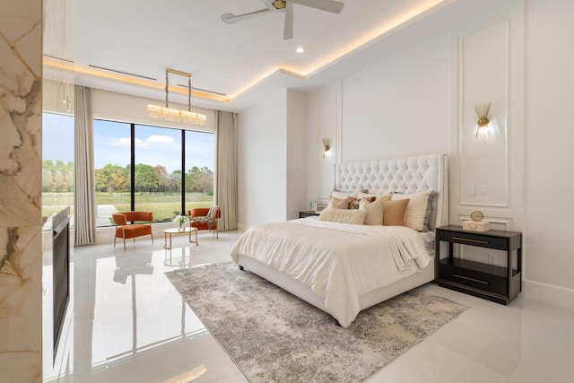 bedroom featuring ceiling fan with notable chandelier, recessed lighting, a raised ceiling, and baseboards