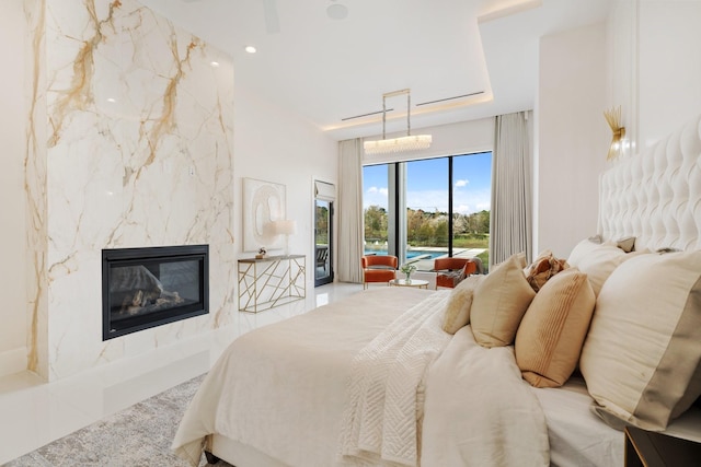 bedroom featuring recessed lighting, a high end fireplace, and access to exterior