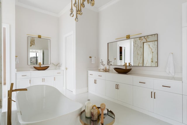 bathroom with crown molding, vanity, and a freestanding bath