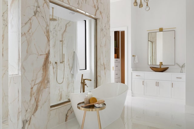 bathroom with marble finish floor, a freestanding tub, a marble finish shower, and vanity