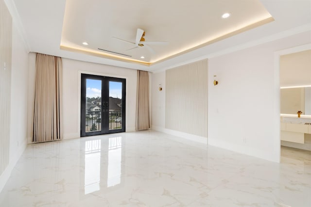 spare room featuring french doors, a tray ceiling, and recessed lighting