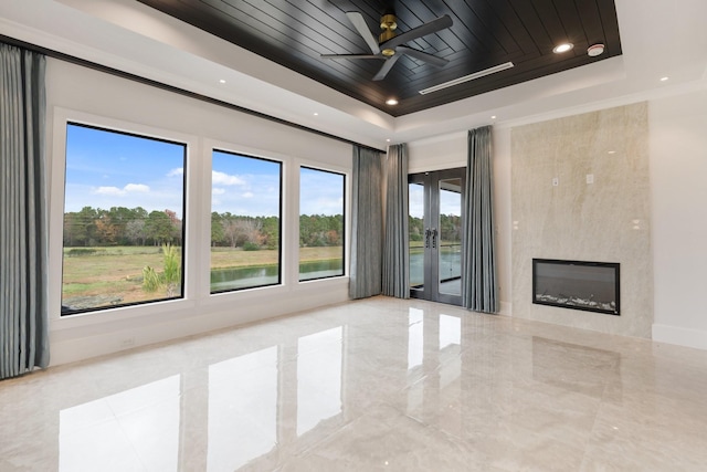 unfurnished living room featuring a tray ceiling, a fireplace, recessed lighting, a ceiling fan, and wooden ceiling