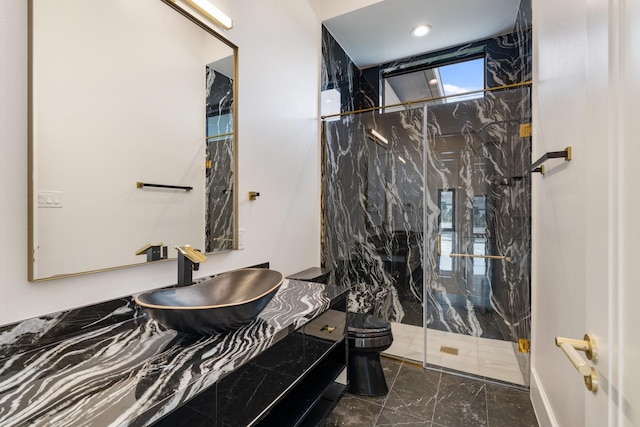 full bath with toilet, marble finish floor, a marble finish shower, and vanity