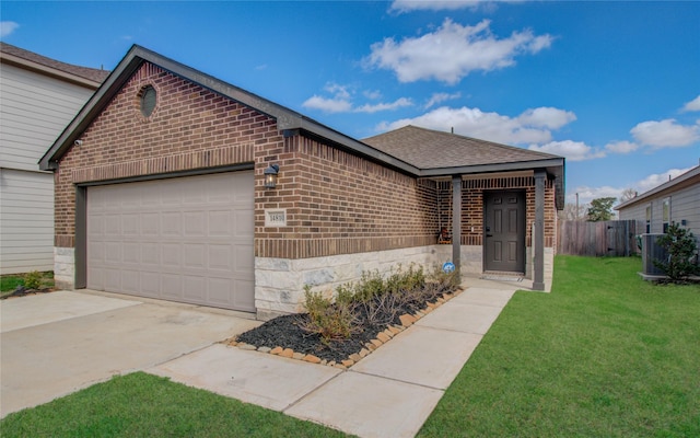 view of front of home featuring a garage, a front yard, and central air condition unit