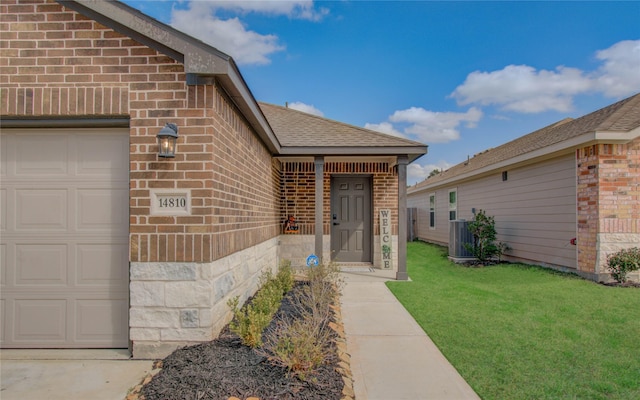 doorway to property featuring a lawn and central air condition unit