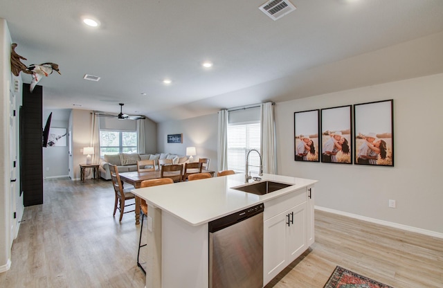 kitchen with a center island with sink, white cabinetry, sink, and stainless steel dishwasher