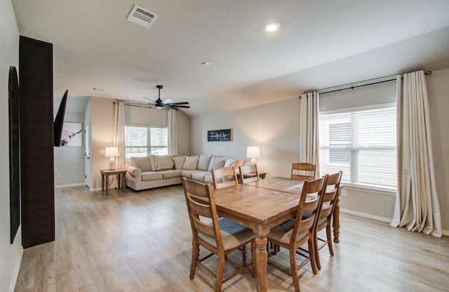 dining area featuring lofted ceiling, ceiling fan, and light hardwood / wood-style flooring