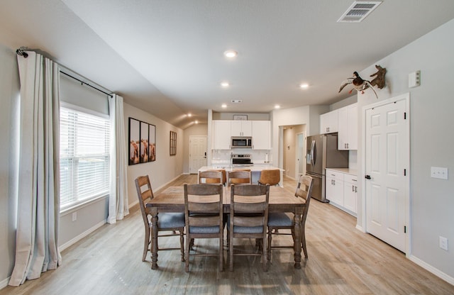 dining space with light wood-type flooring