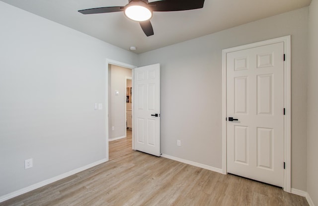 unfurnished bedroom with ceiling fan and light wood-type flooring