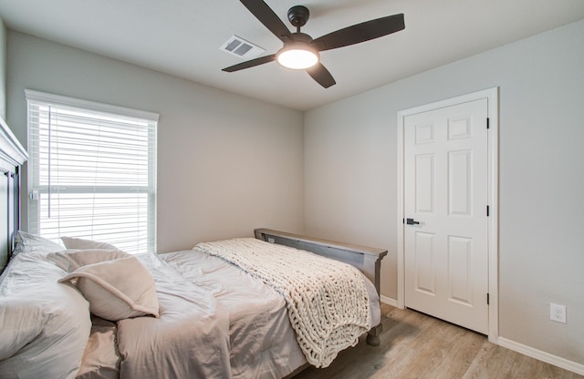 bedroom with ceiling fan and light hardwood / wood-style floors