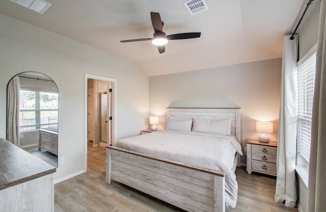 bedroom with ceiling fan, light hardwood / wood-style floors, and vaulted ceiling