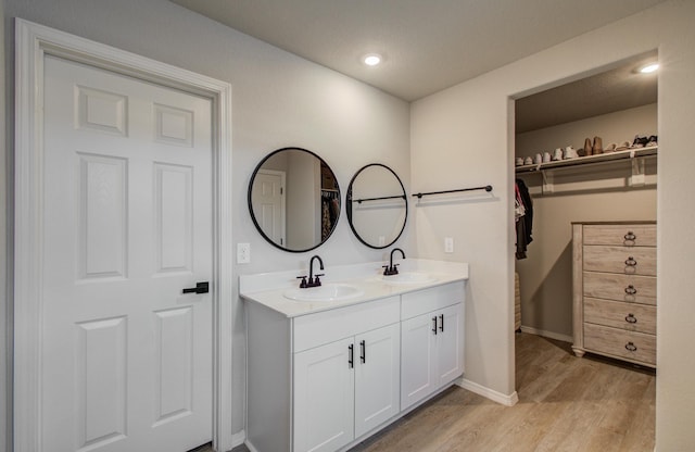 bathroom with vanity and hardwood / wood-style flooring