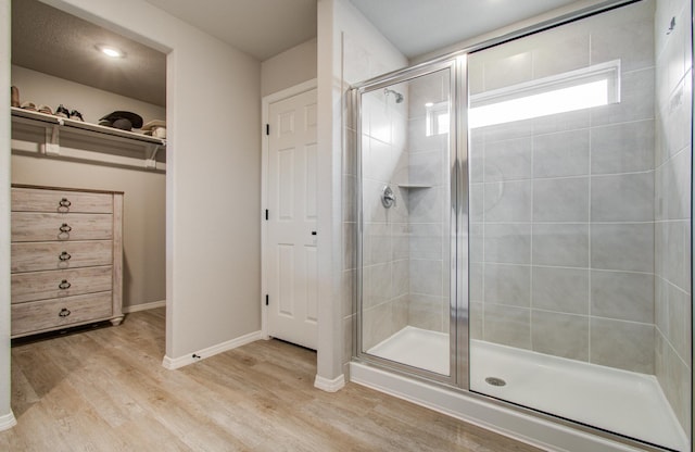 bathroom featuring wood-type flooring and walk in shower