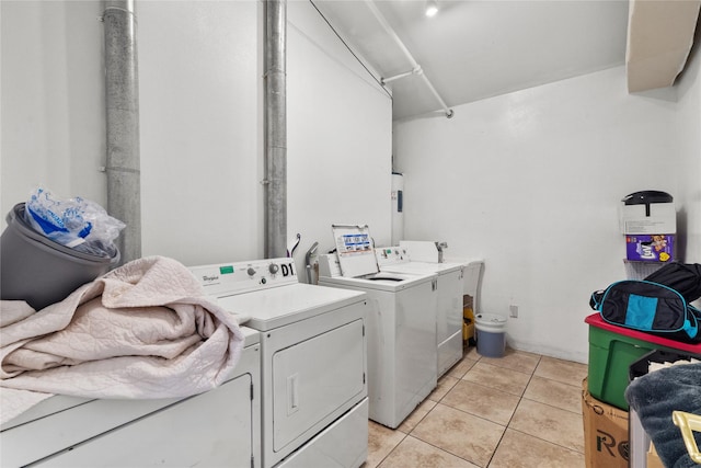 washroom with washer and clothes dryer and light tile patterned floors