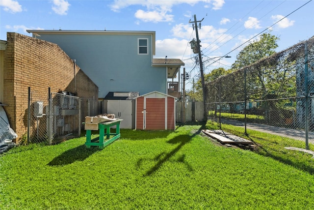 back of property with a lawn and a storage unit