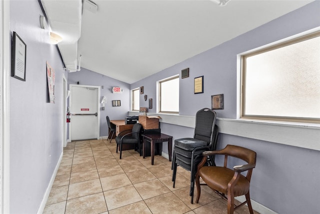 tiled dining space with vaulted ceiling