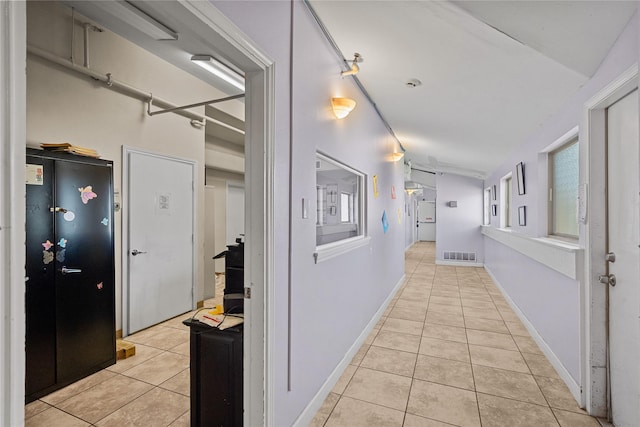 corridor featuring light tile patterned floors