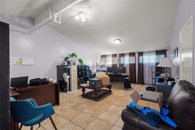 office area featuring vaulted ceiling and light tile patterned flooring