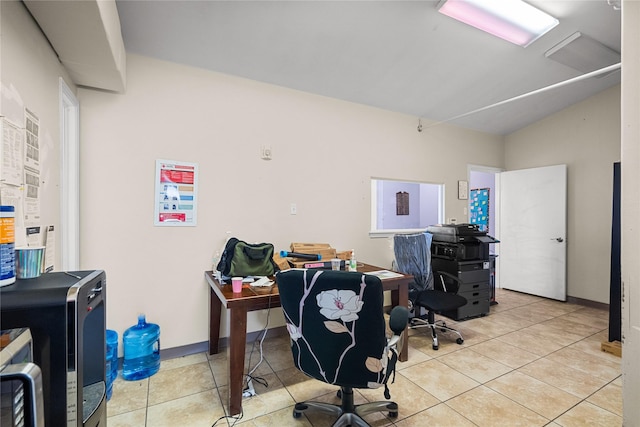 home office featuring vaulted ceiling and light tile patterned floors