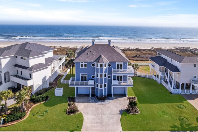 drone / aerial view with a water view and a view of the beach