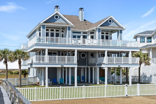 back of property featuring a yard and a balcony