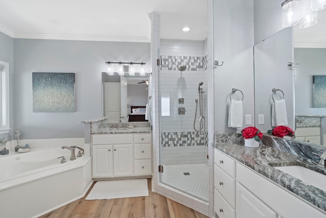 19307 Shores Dr, Galveston, TX 77554 - bathroom featuring hardwood / wood-style flooring, ornamental molding, shower with separate bathtub, and vanity