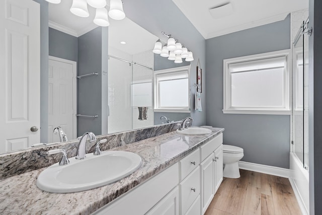 19307 Shores Dr, Galveston, TX 77554 - full bathroom featuring toilet, crown molding, vanity, enclosed tub / shower combo, and hardwood / wood-style floors