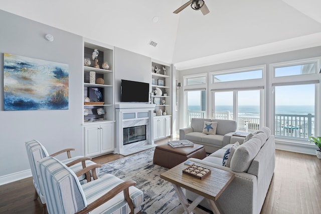 19307 Shores Dr, Galveston, TX 77554 - living room with hardwood / wood-style floors, built in features, high vaulted ceiling, ceiling fan, and a premium fireplace