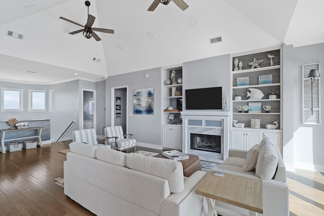 19307 Shores Dr, Galveston, TX 77554 - living room with high vaulted ceiling, a fireplace, hardwood / wood-style floors, and built in features
