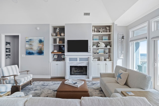19307 Shores Dr, Galveston, TX 77554 - living room with built in shelves, light hardwood / wood-style flooring, high vaulted ceiling, and a premium fireplace
